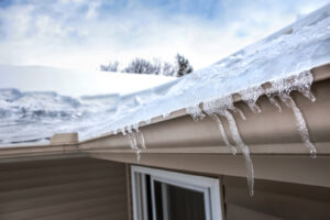 A closeup image of an ice dam that has formed in a residential gutter system.